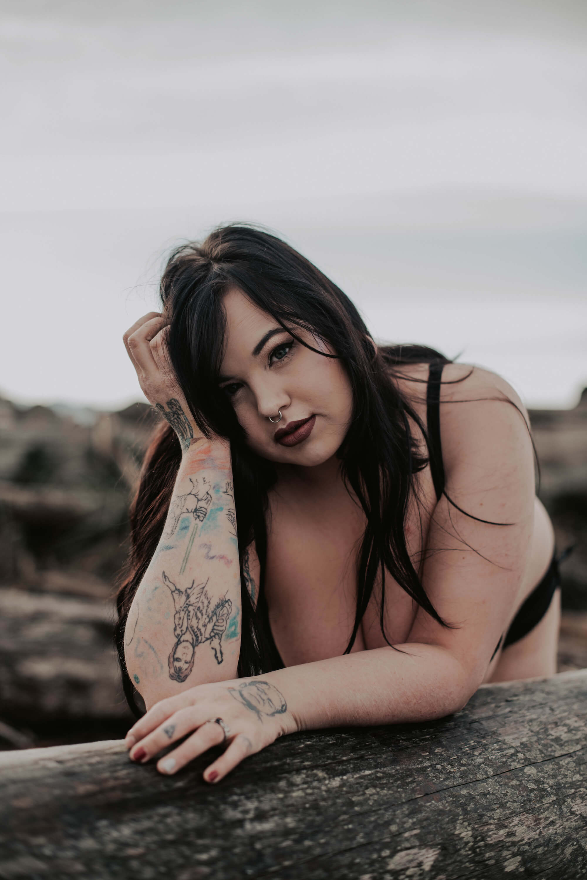 tattooed woman posing on northwest beach