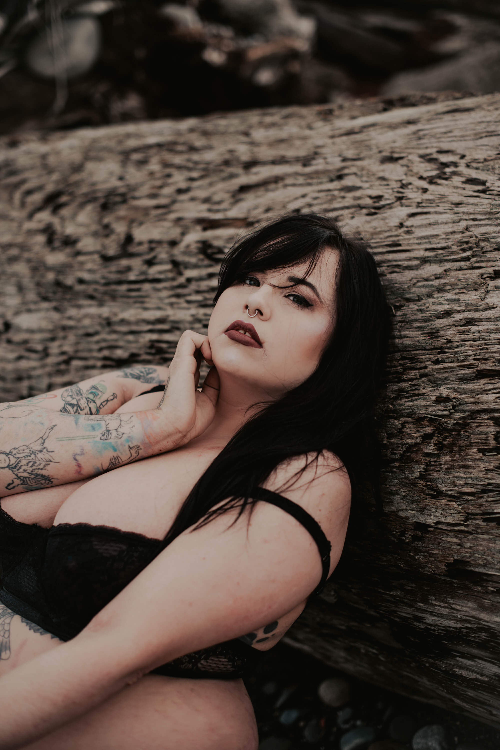 tattooed woman posing on cold pacific northwest beach