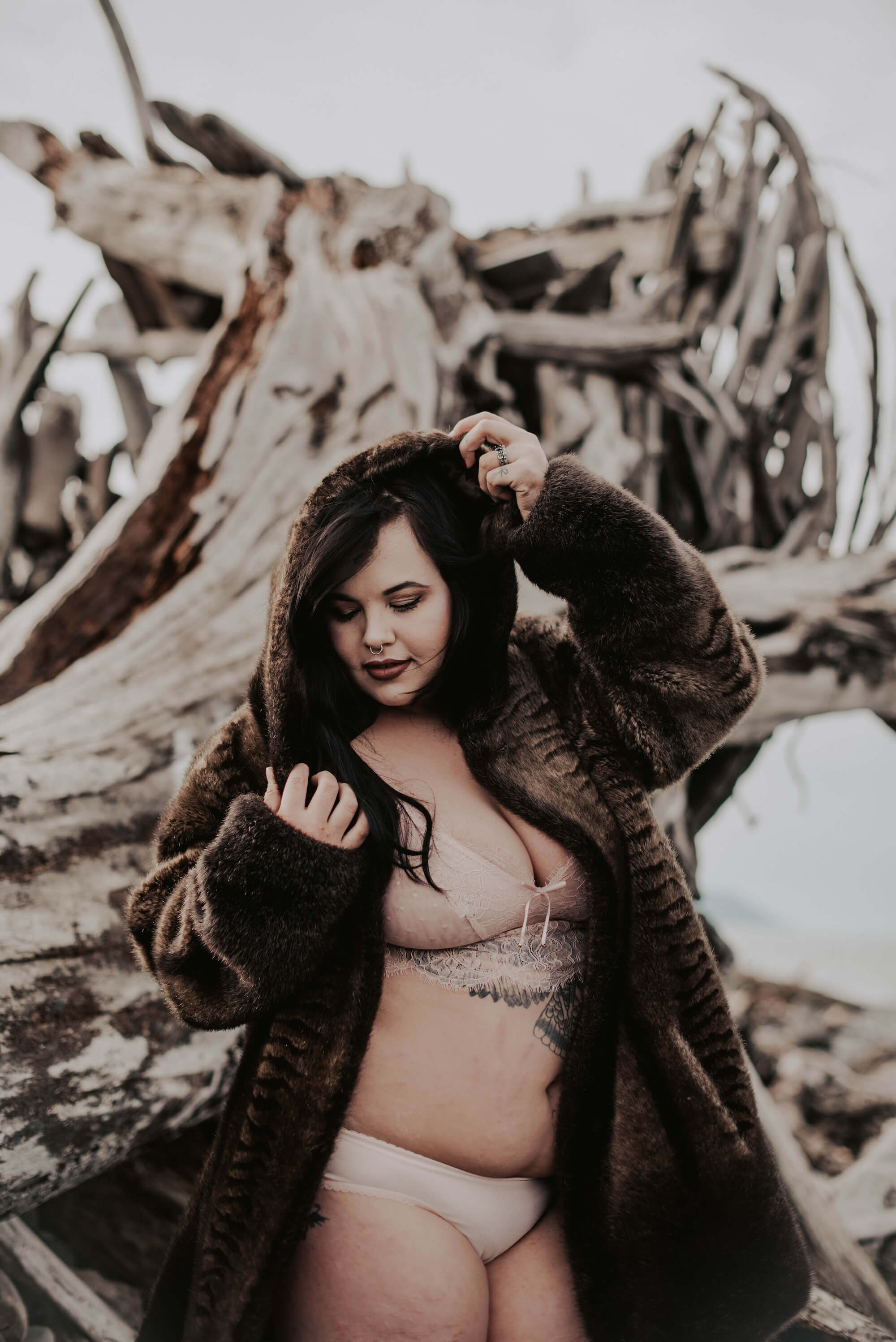 woman in brown fur coat on cold pnw beach