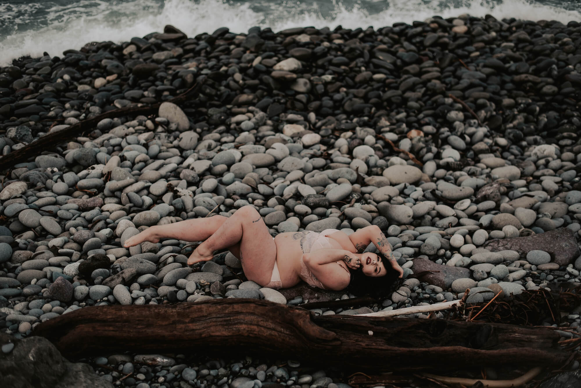 woman lying on rock on port angeles outdoor boudoir session