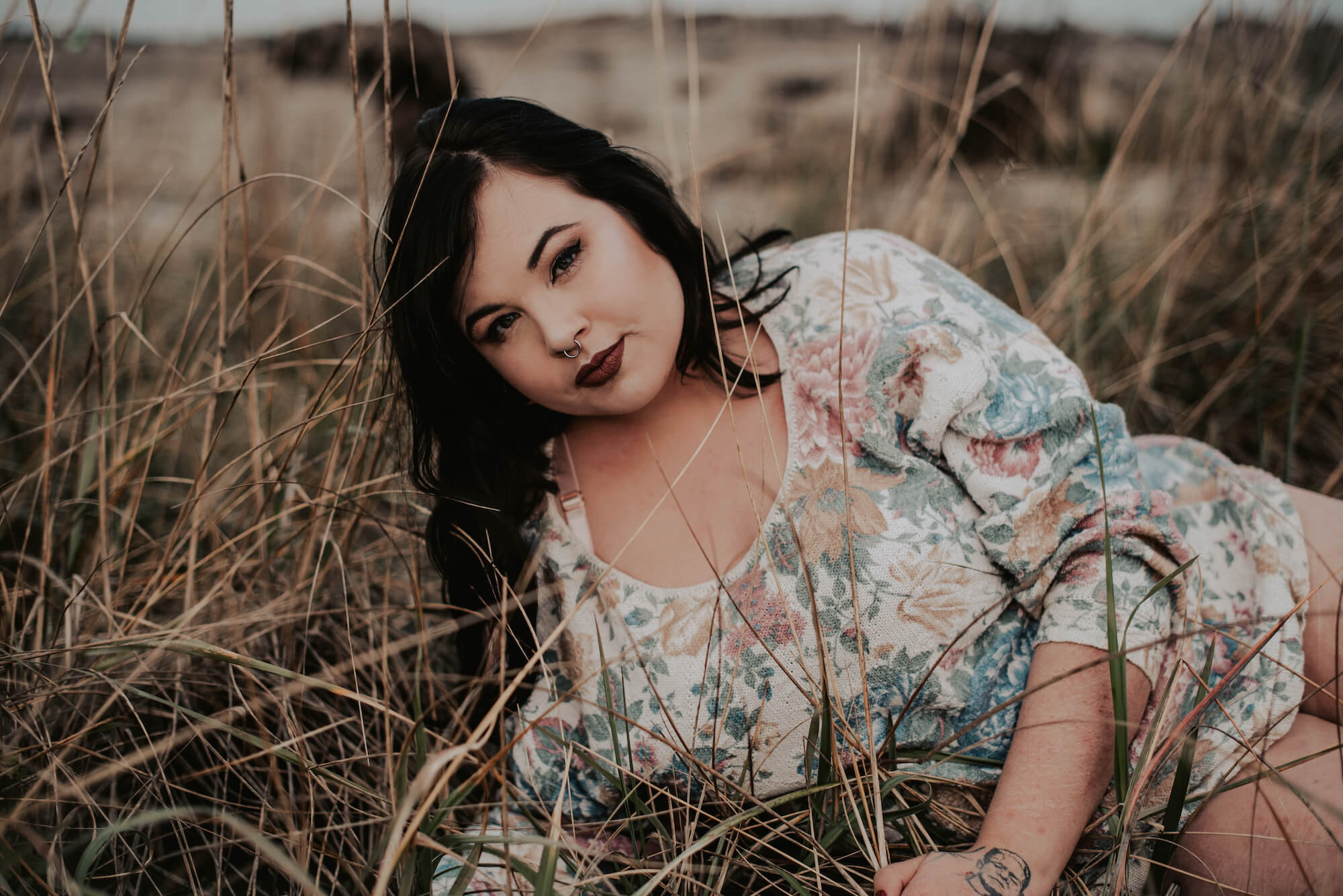 woman in sweater lying in tall grass in port angeles