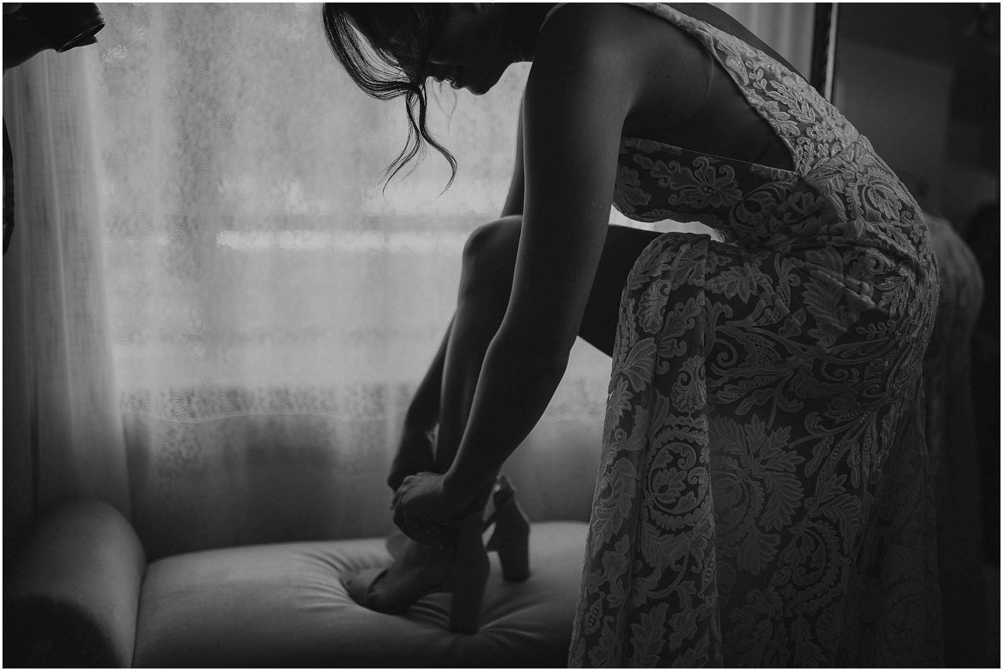 bride putting on wedding shoes,