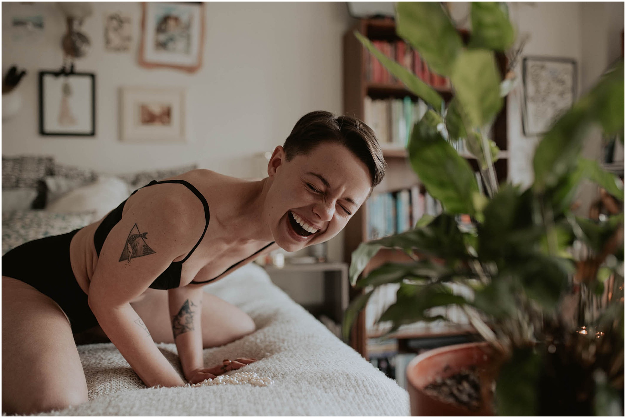 laughing on bed in lingerie 