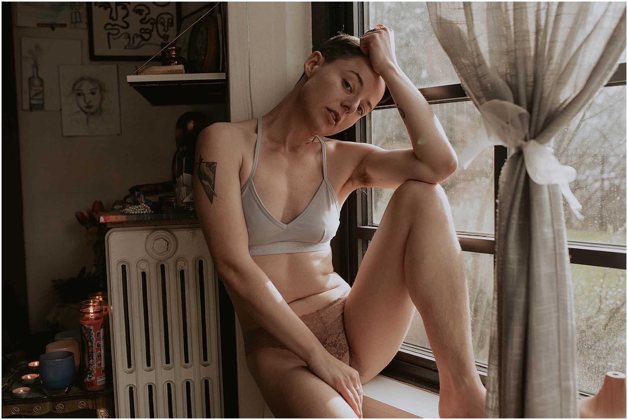 boudoir pose on windowsill in seattle apartment 