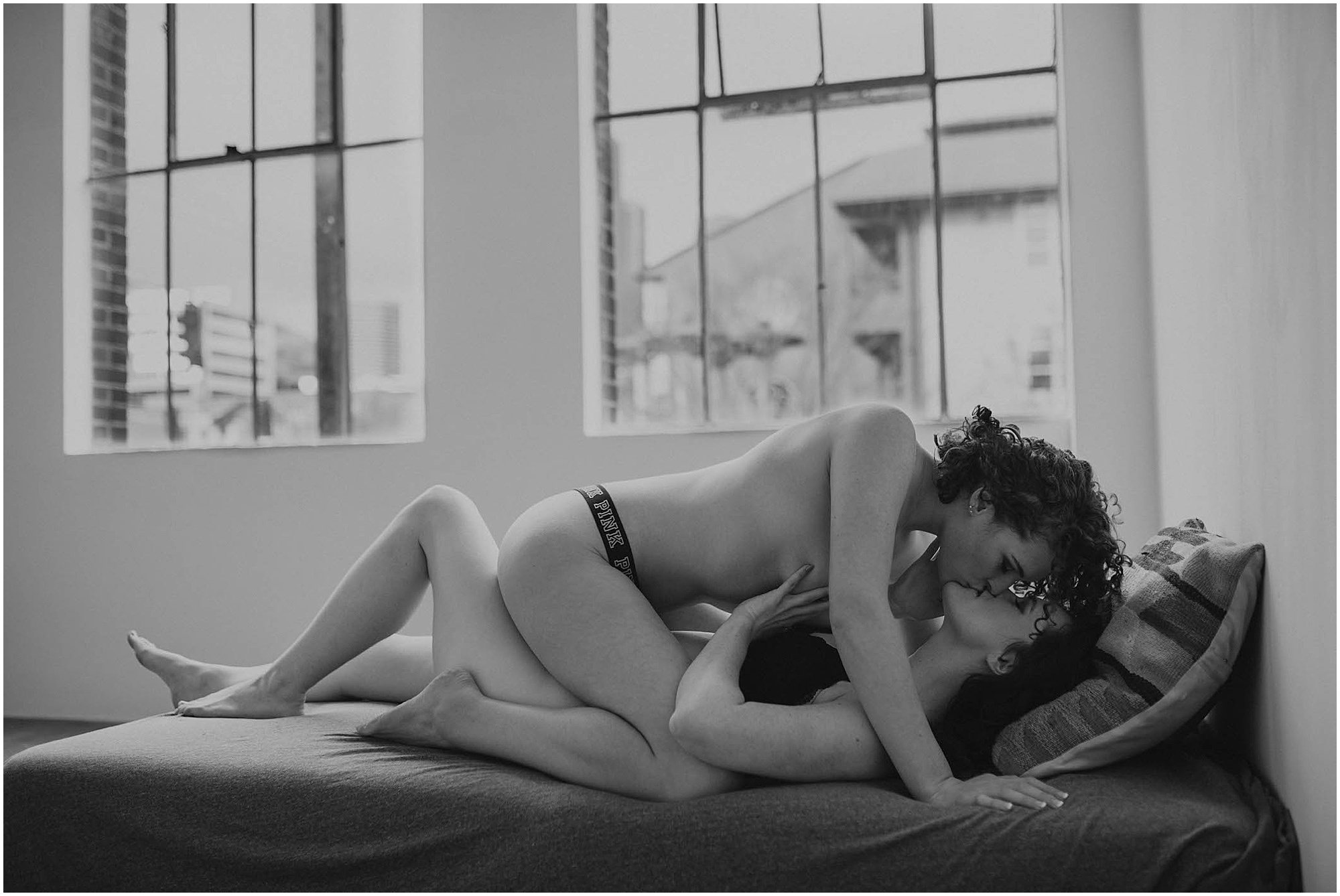 couple making out on bed in seattle studio