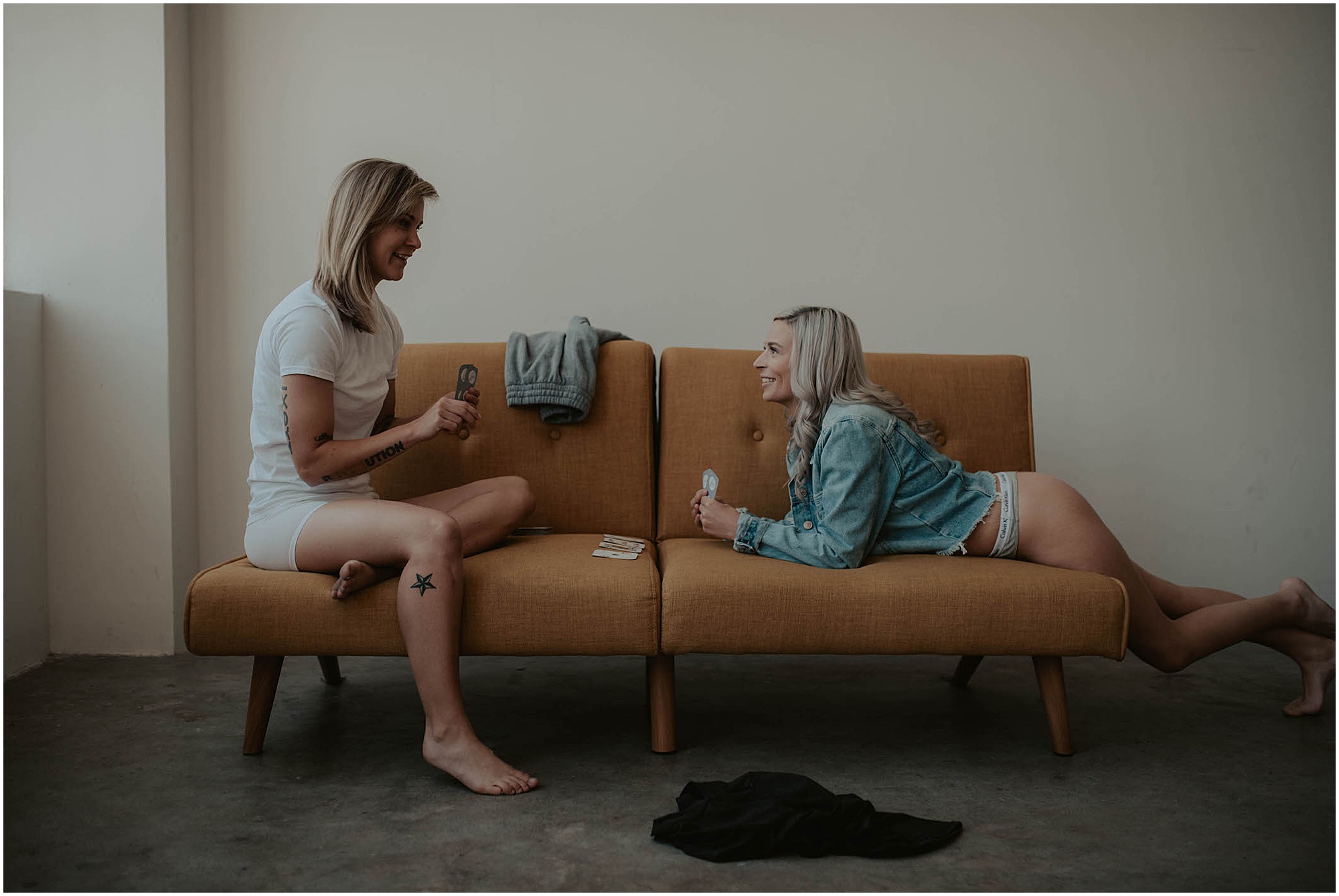 couple playing strip poker on couch, humano studio in seatte, engayged 