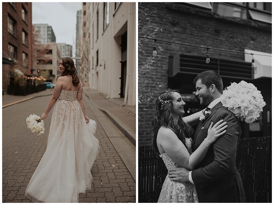 bride and groom posing in front of brick wall with all white bouquet