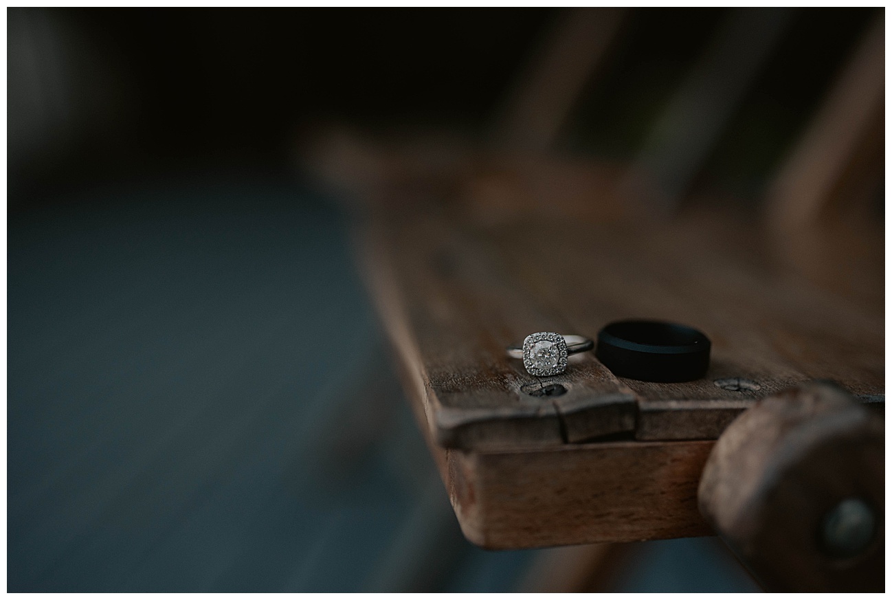 bride and grooms wedding rings on wooden table