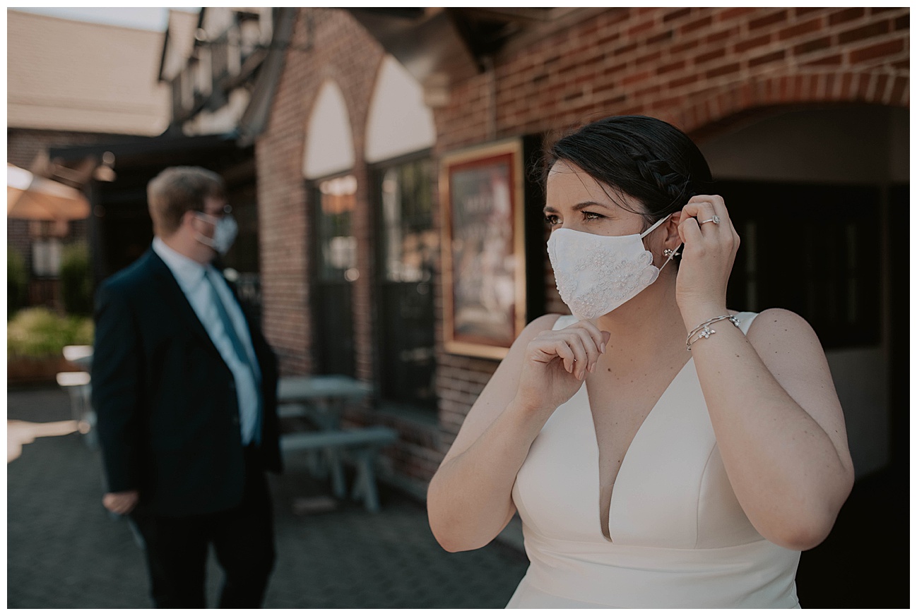 bride wearing white beaded mask on wedding day during covid
