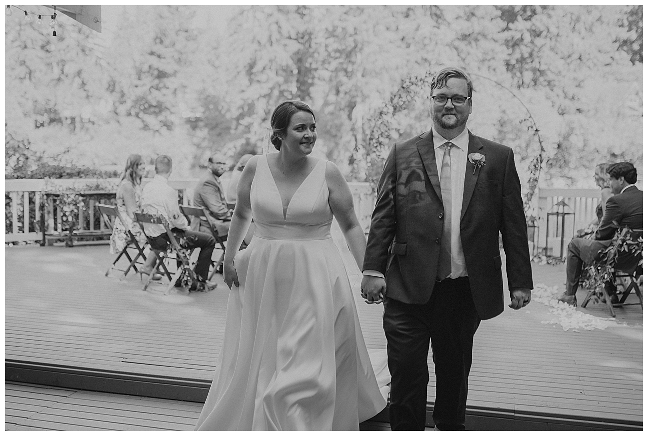 bride and groom walking down the aisle after intimate wedding ceremony
