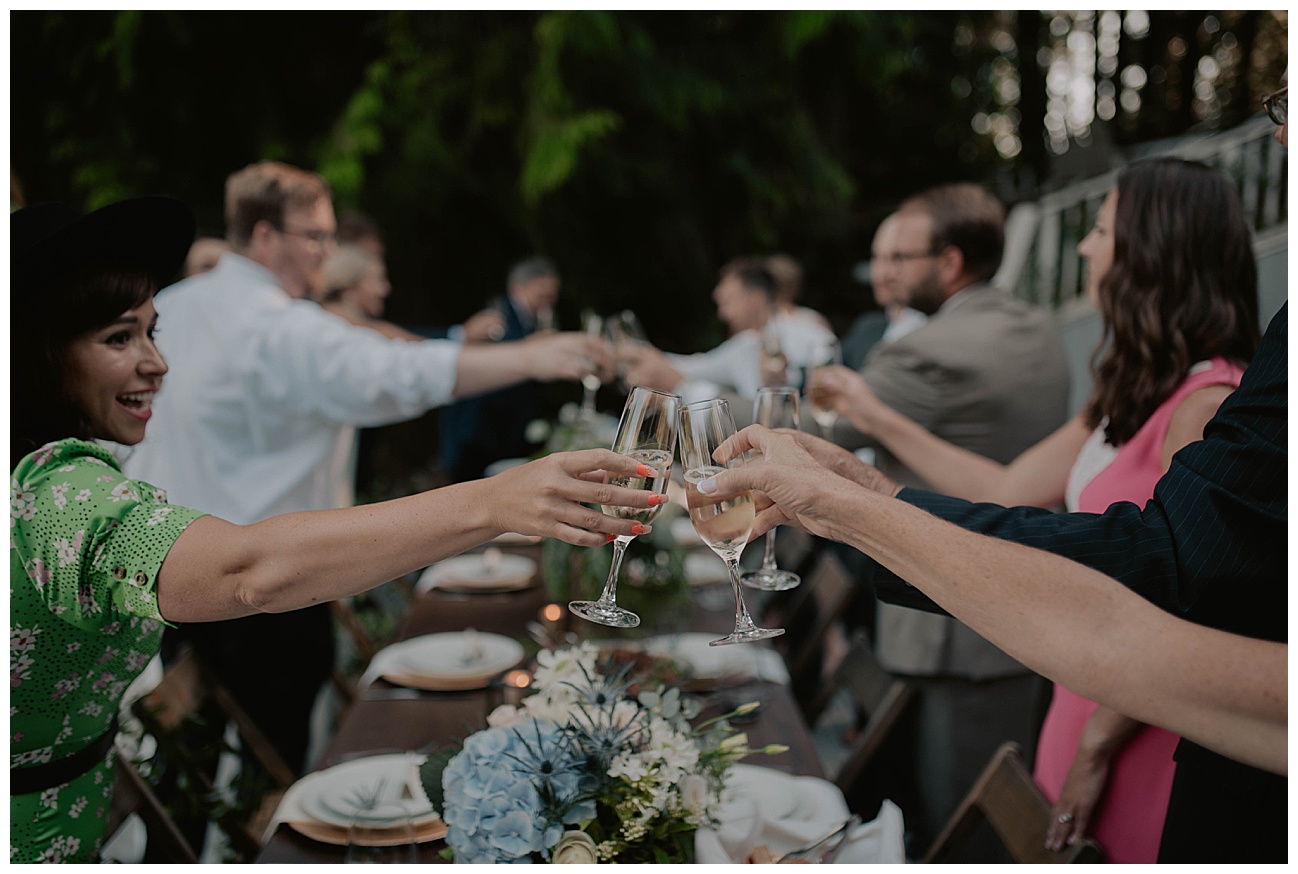cheers on wedding day during intimate wedding reception