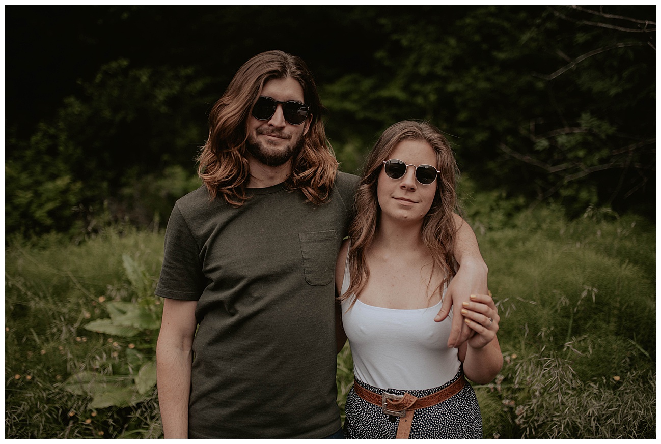 engaged couple wearing sunglasses