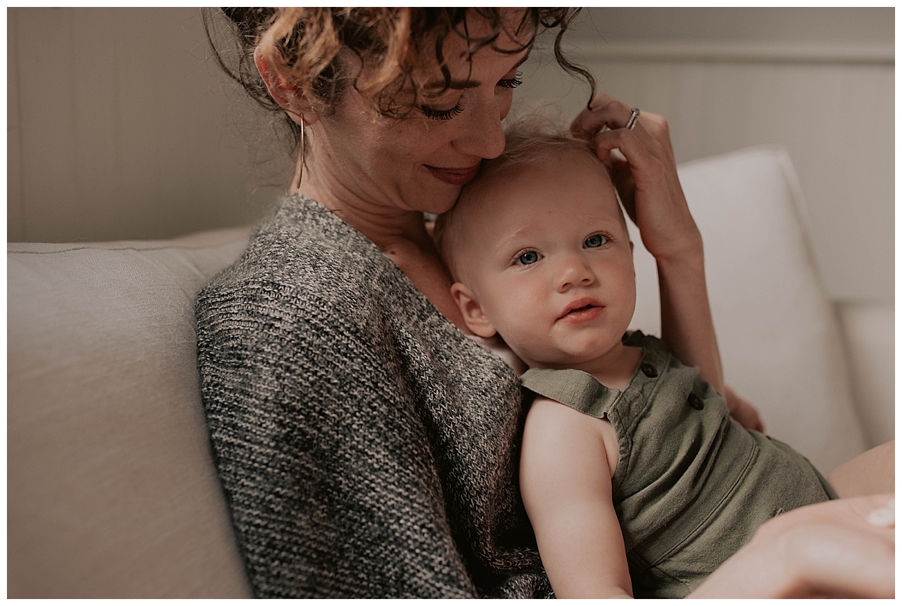 mom and daughters snuggling on couch