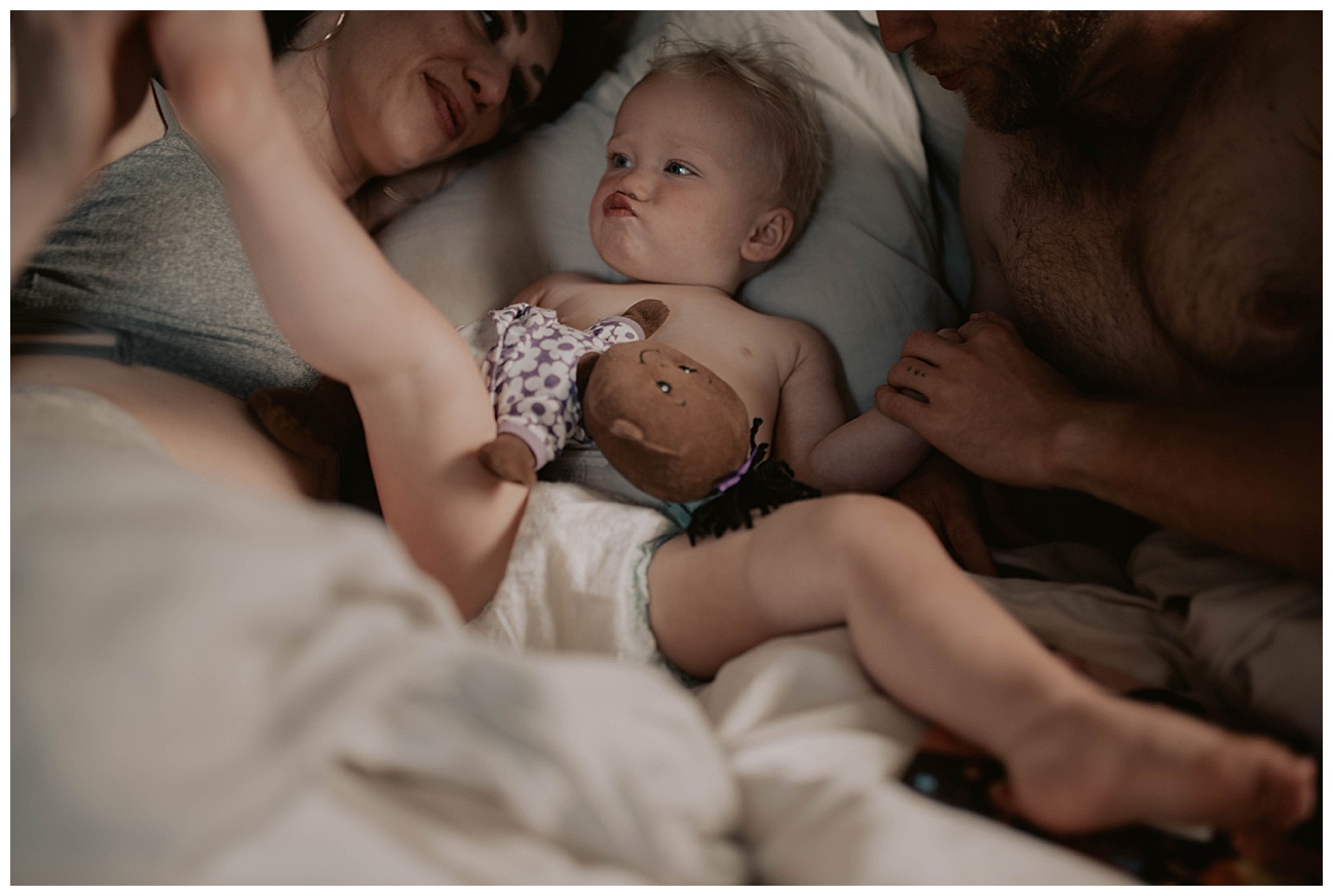 family lounging in bed on a summers day