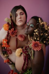 two models covered in colorful flowers