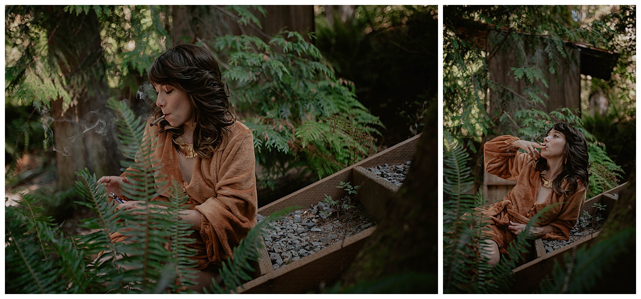 woman in orange robe lighting a joint in pnw forest