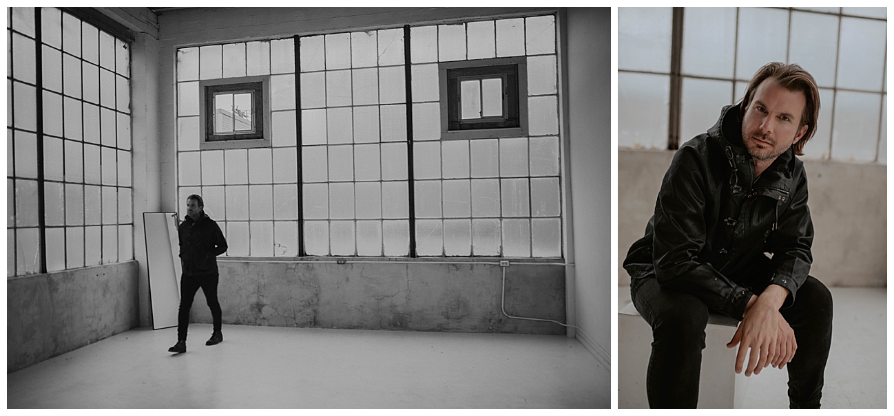 man in all black posing in new york styled photo studio