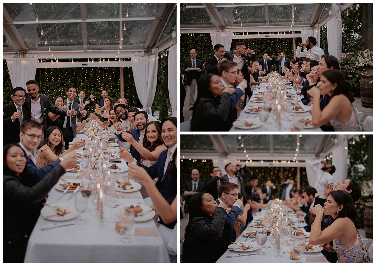 table of people at wedding reception taking a shot