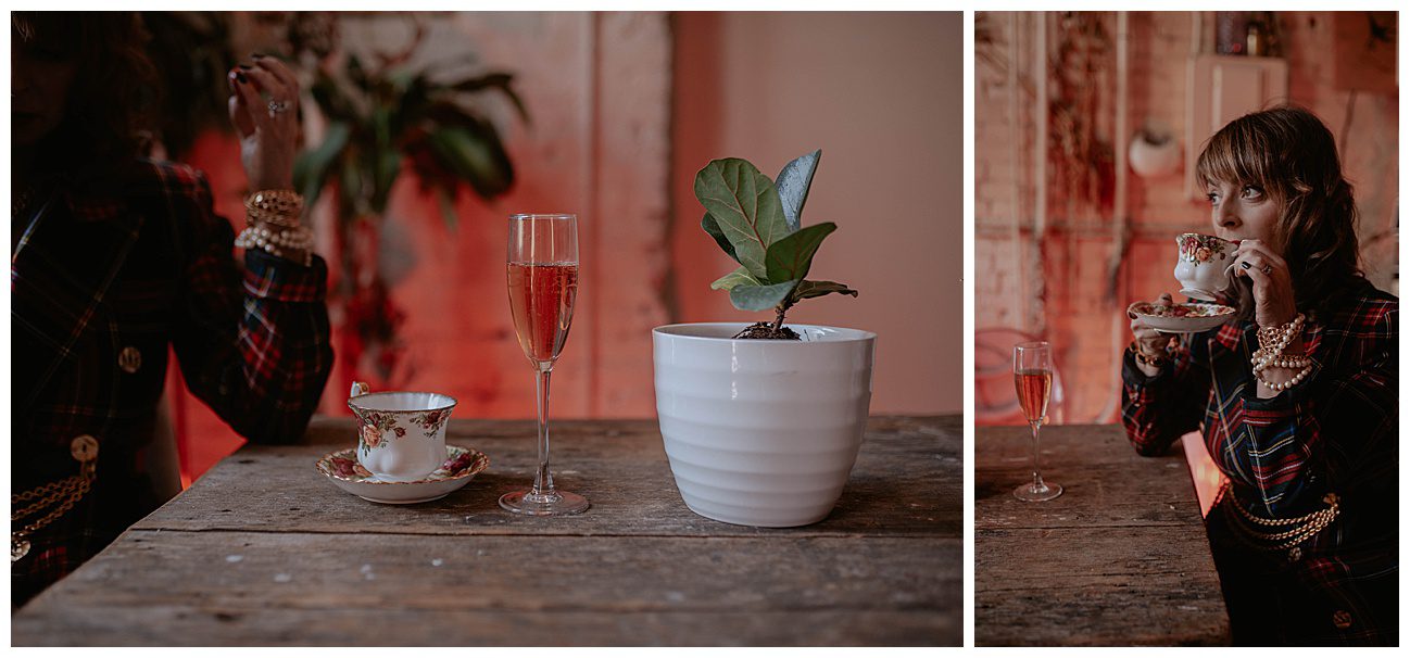 woman sipping rose out of a tea cup in white brick wall pioneer square loft