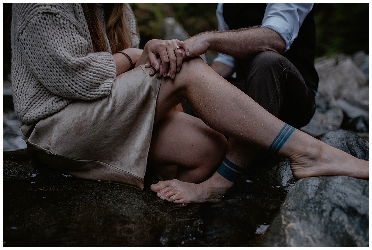 Adventure Engagement- Couples boudoir session with Kelly and Conner in the Cascade Mountains by Kendra K Photo kendrakphoto.com couples matching leg tattoos sitting in river bead