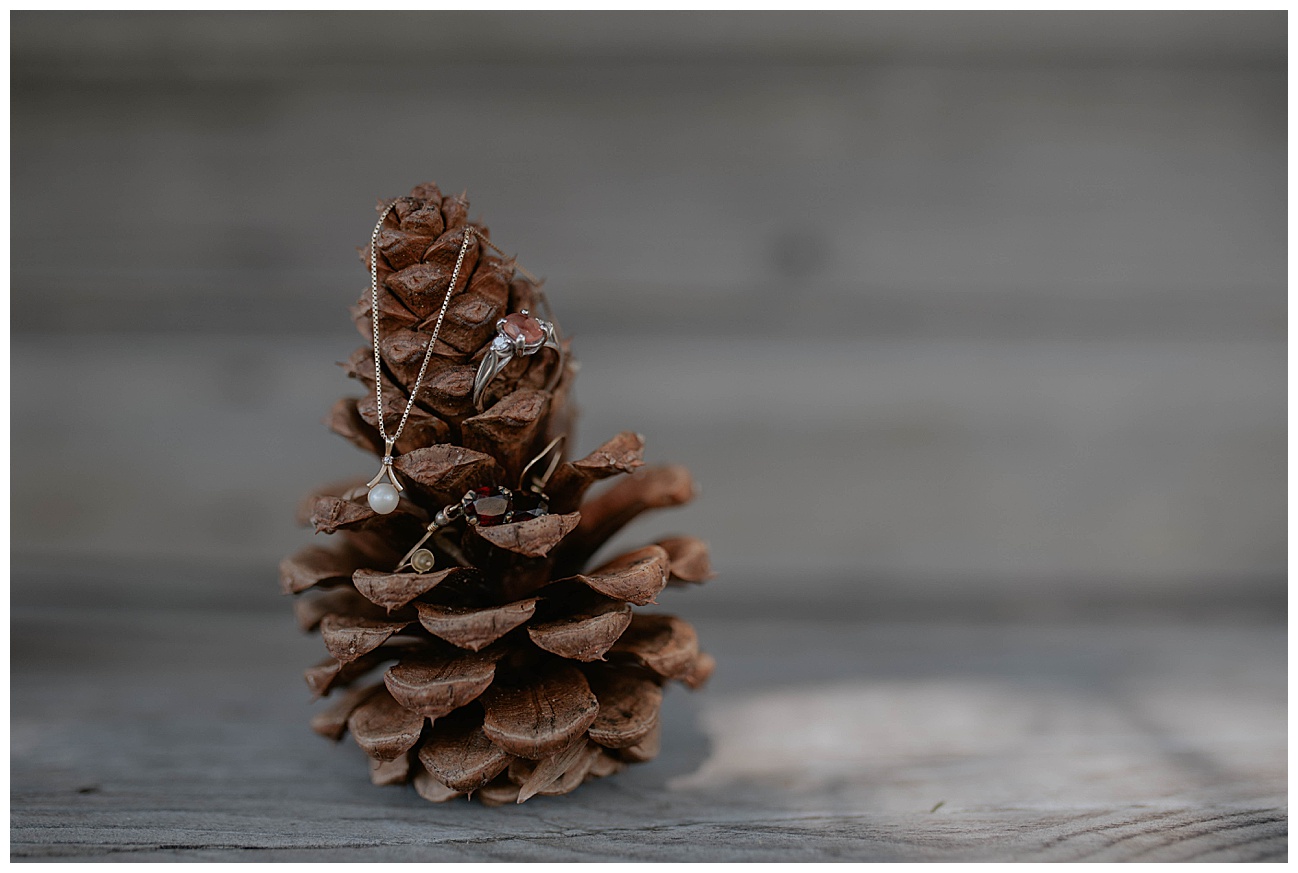 brides wedding day accessories in a pinecone