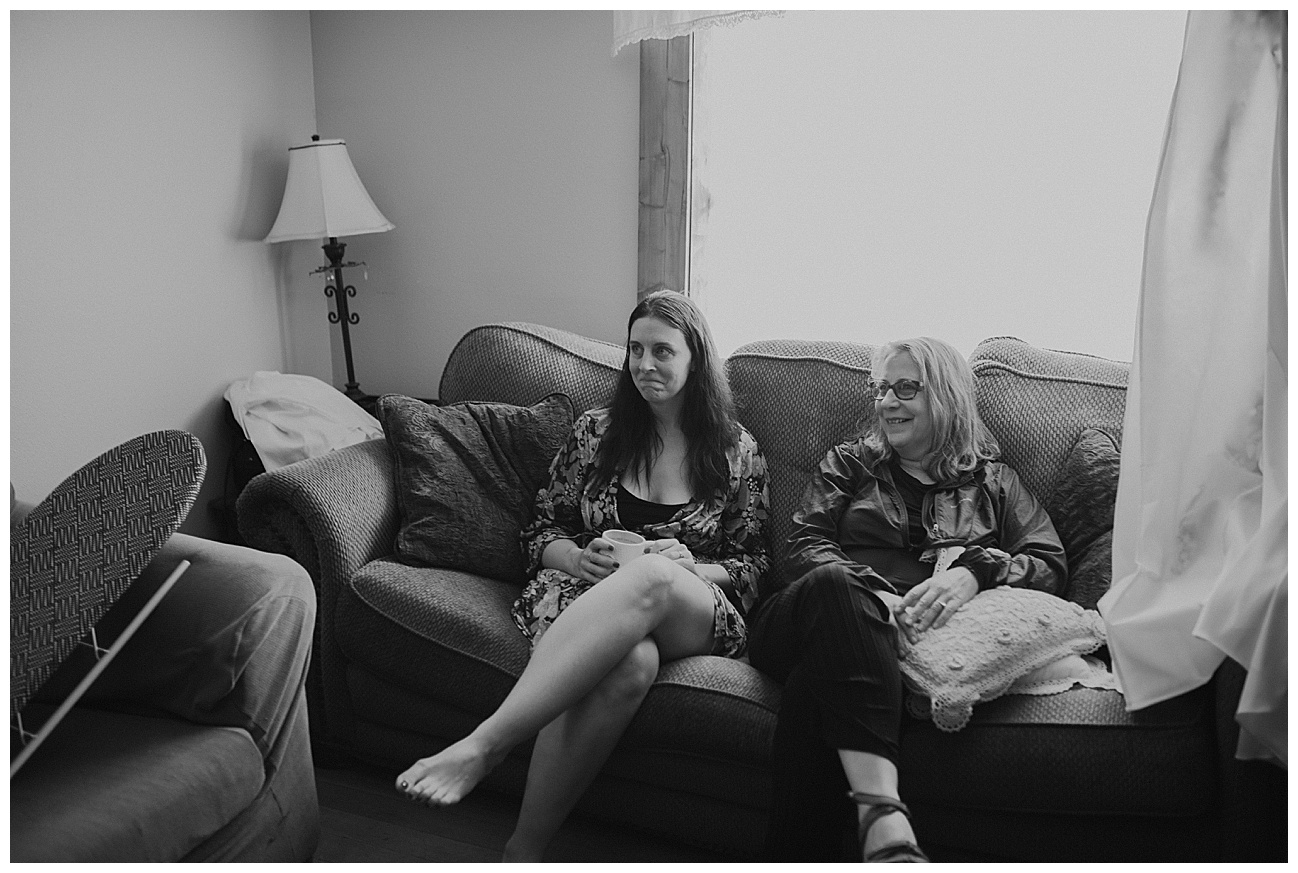 bride sitting on couch with her mom