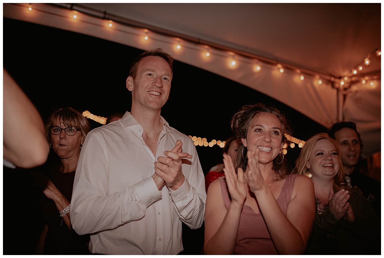 wedding guests cheering for bride and groom 