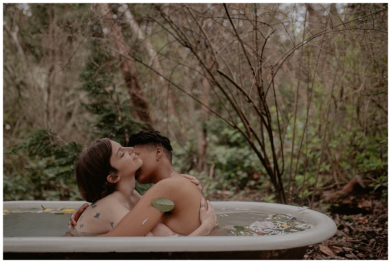 Tatted woman, outdoor clawfoot bathtub, outdoor boudoir, bath boudoir, flowers in water, couple in bathtub