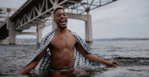 man with shall in lake Washington under bridge